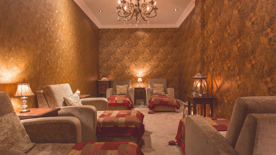 Elegant relaxation lounge with plush armchairs, warm lighting, luxurious decor, perfect for unwinding in style.