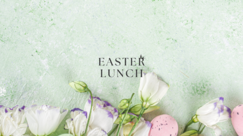 Celebrate Easter lunch with vibrant white flowers and pastel eggs on a soft green backdrop, promising a delightful spring experience.