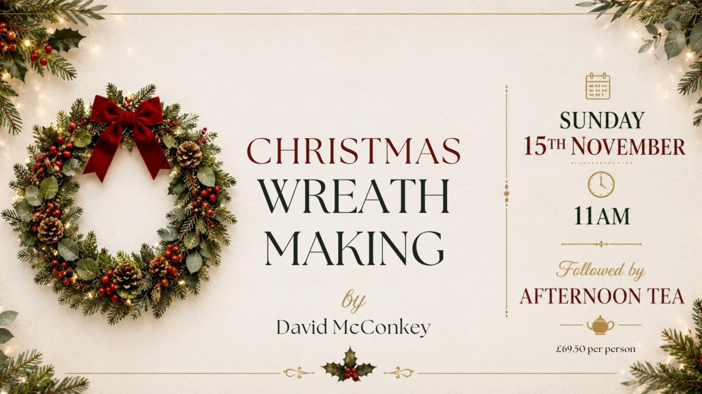 Christmas wreath-making workshop with afternoon tea at a cosy hotel, featuring a festive wreath with pinecones and red berries.