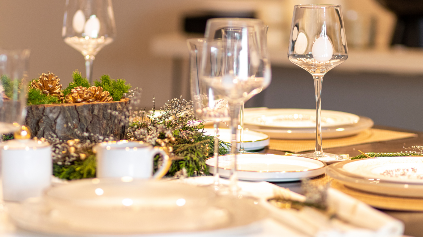 Elegant dining table with nature-inspired décor, refined china, and gleaming glassware at luxurious hotel restaurant.