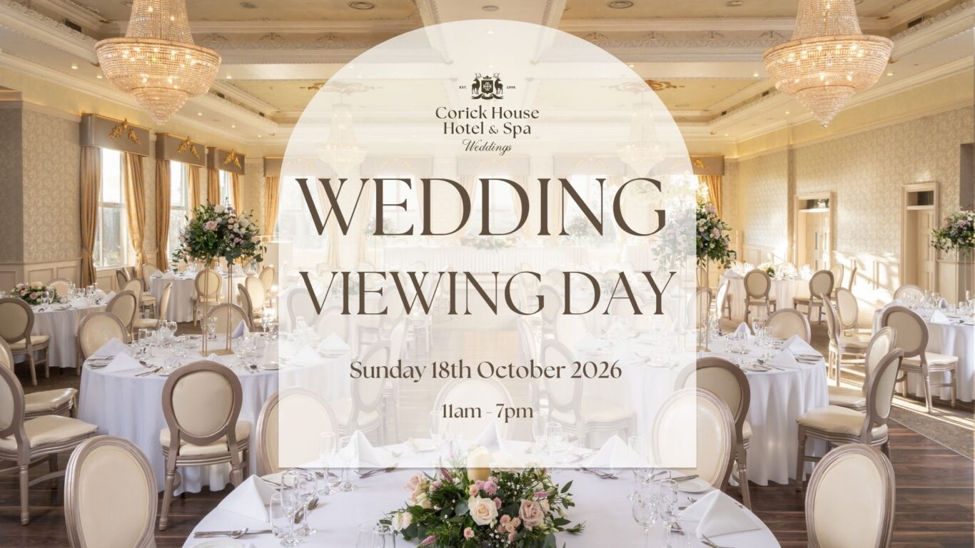 Elegant wedding venue with chandeliers, floral arrangements, and luxurious seating for a sophisticated wedding experience.